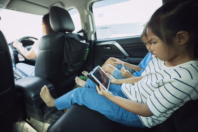 Rear view of woman sitting in car