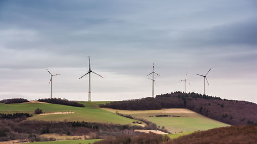 Windmill on field against sky