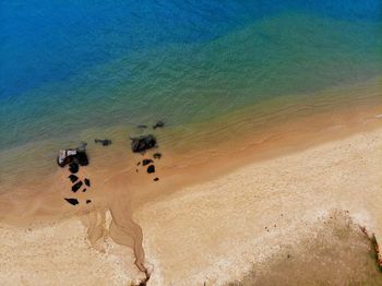 High angle view of rocks on beach against sky