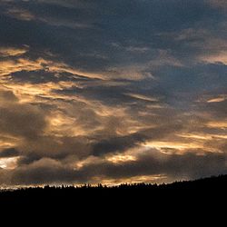 Scenic view of landscape against sky at sunset