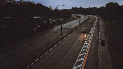 High angle view of railroad tracks by road against sky