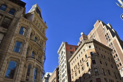 Low angle view of buildings against blue sky