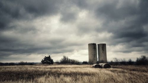 View of factory against cloudy sky