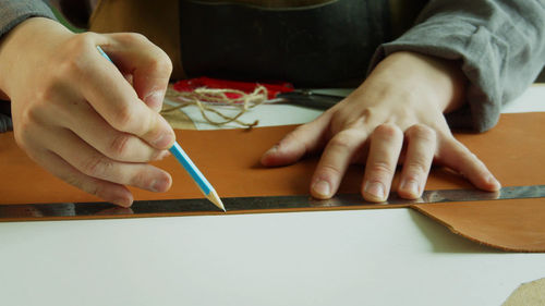 Midsection of man working on table