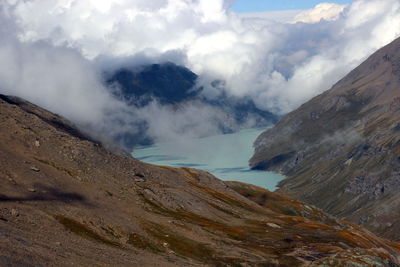 Scenic view of blue alpine lake landscape against sky