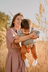 Mother and son on daughter outdoors