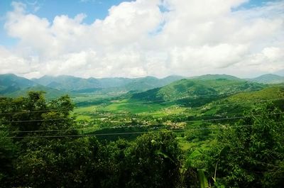 Scenic view of green landscape against sky