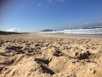 Scenic view of beach against blue sky