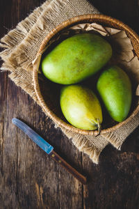 High angle view of fruits in basket on table