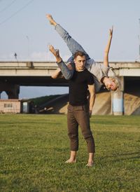 Full length of young man standing on field