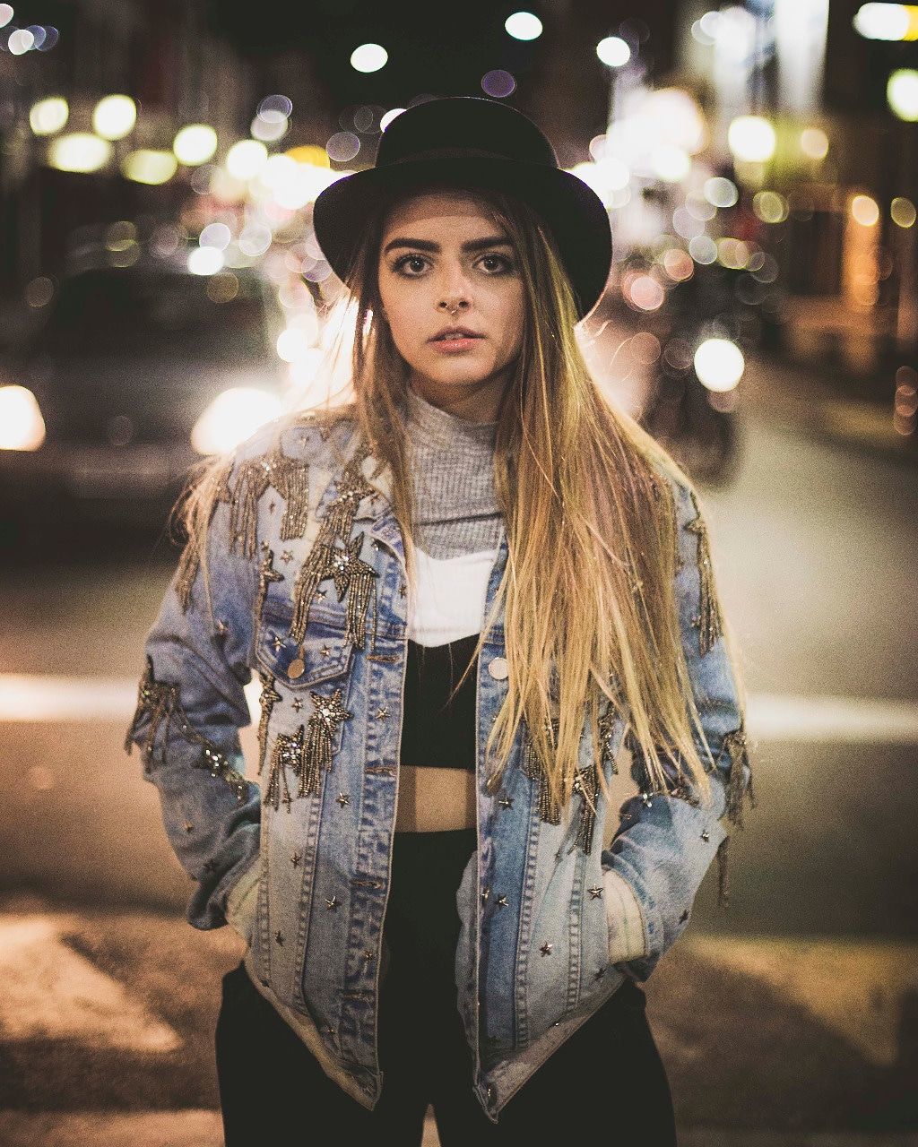 looking at camera, one person, clothing, hat, lifestyles, real people, portrait, leisure activity, young adult, three quarter length, city, focus on foreground, hair, night, front view, long hair, young women, beautiful woman, hairstyle, outdoors, warm clothing, scarf