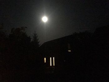 Low angle view of illuminated street light against sky at night