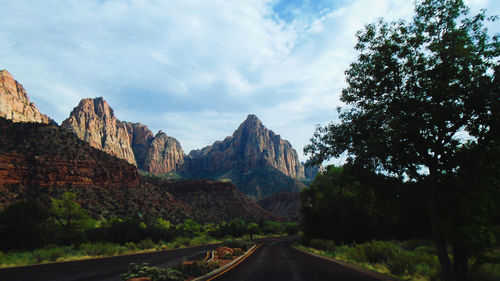 Panoramic view of road by mountains against sky