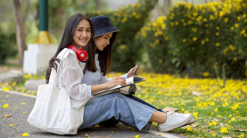 Young woman smiling while sitting outdoors