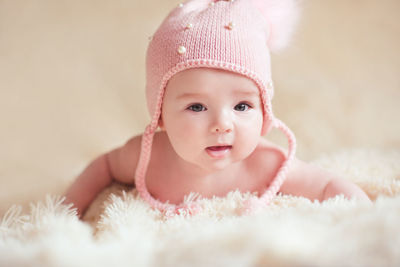 Portrait of cute baby on bed