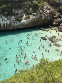 High angle view of people on rocks at beach