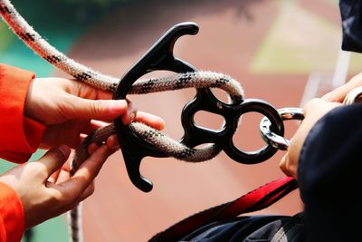 Close-up of hands preparing safety equipment