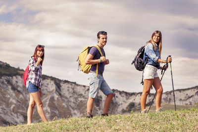 Group of young hikers in the mountain in single file