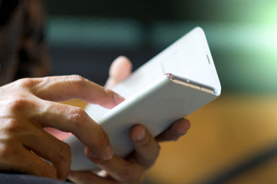 Close-up of hand holding mobile phone