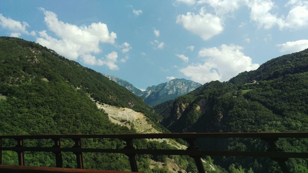 mountain, mountain range, tranquil scene, tranquility, scenics, beauty in nature, sky, landscape, nature, green color, railing, tree, non-urban scene, idyllic, cloud - sky, valley, fence, cloud, remote, day