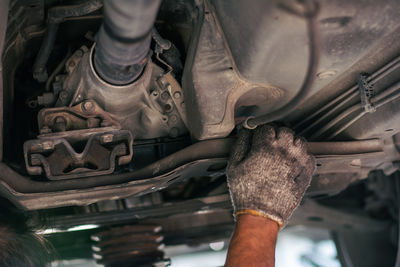 Low section of man working on machine
