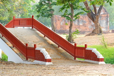 Staircase leading towards gazebo in forest