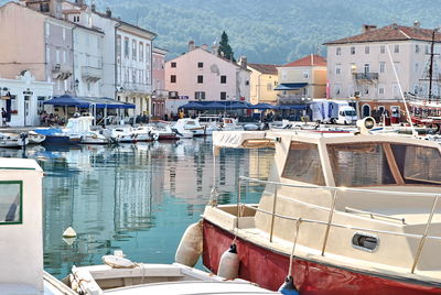 Sailboats moored in city