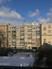 Buildings in city against sky during winter