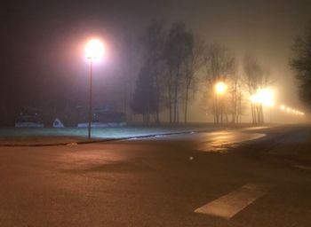 View of snow covered road at night