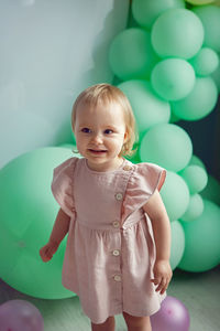 Cute baby girl with balloons