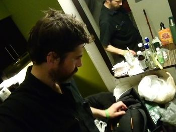 Side view of young man sitting at restaurant table