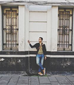 Full length of man standing against building in city