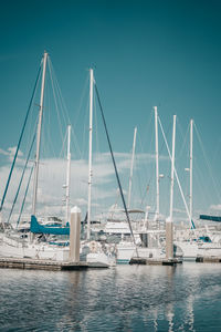 Sailboats in sea against clear sky