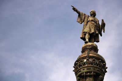 Low angle view of statue against sky