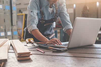 Midsection of woman working on table