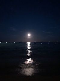 Scenic view of sea against sky at night