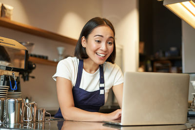 Young woman using laptop at home