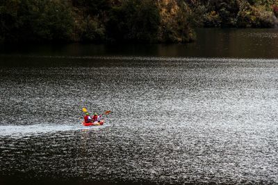 Men sitting on boat in river