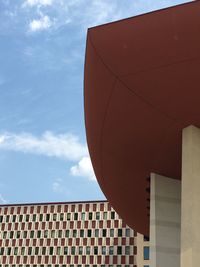 Low angle view of building against cloudy sky