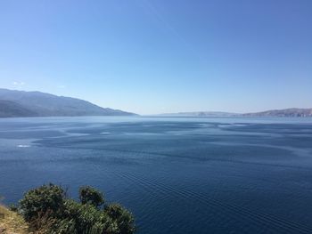 Scenic view of sea against clear blue sky