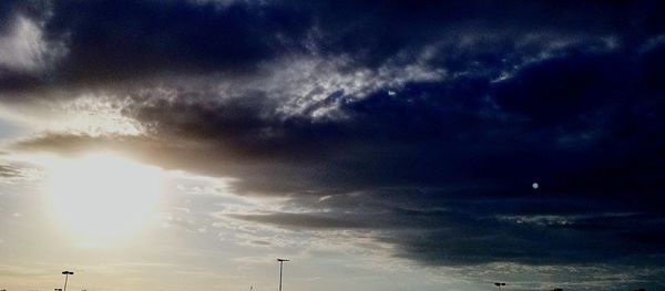 Low angle view of silhouette lightning against sky during sunset