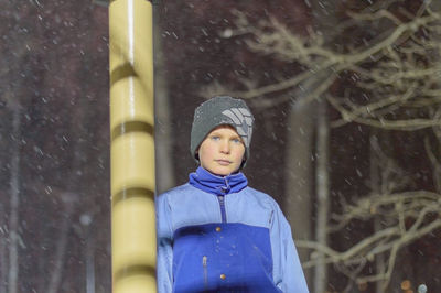 Close-up of young woman standing in snow