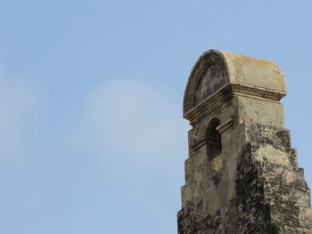 Low angle view of old building against blue sky