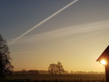 Scenic view of field against sky at sunset