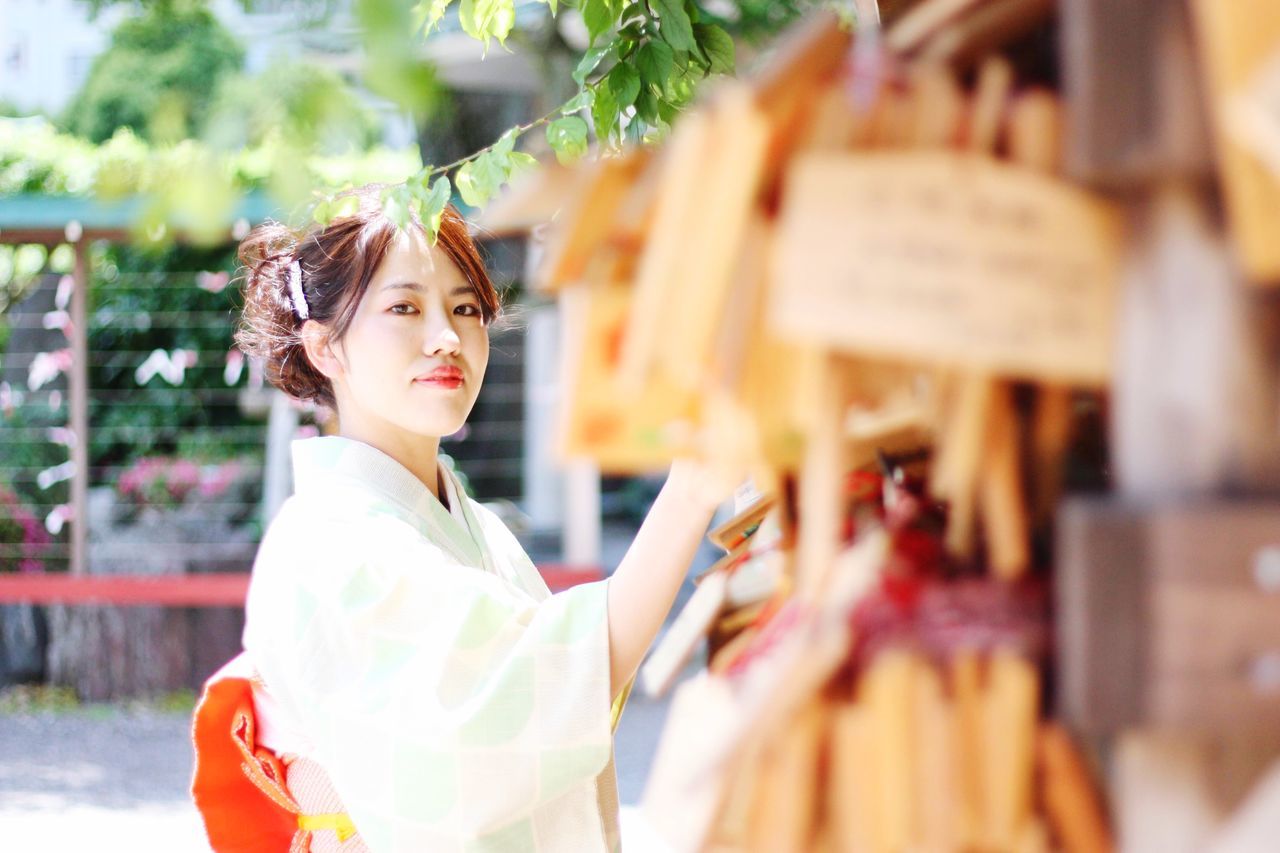 one person, young adult, young women, real people, selective focus, women, beautiful woman, portrait, beauty, store, looking at camera, adult, looking, retail, leisure activity, casual clothing, standing, lifestyles, hairstyle, contemplation, consumerism