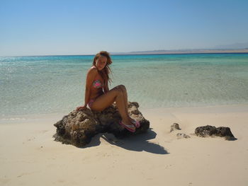 Woman sitting on beach