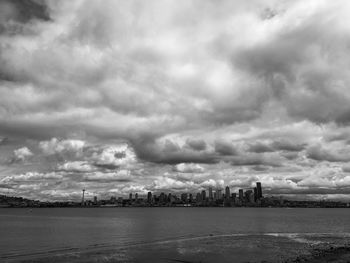 Scenic view of river against cloudy sky