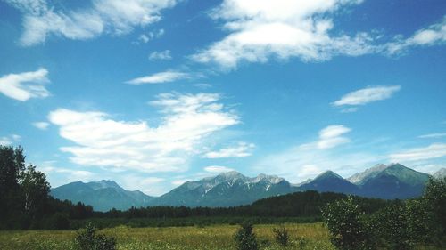 Scenic view of landscape against cloudy sky