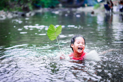 Portrait of happy boy swimming in water