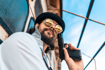 Portrait of young man holding camera